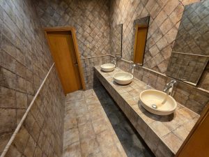 Guest bathroom with classic tile design and double sinks in a fully renovated villa for rent in Jumeirah 3 Dubai