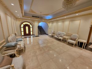 Luxury majlis living room with classic decor and chandeliers in a renovated villa in Jumeirah Dubai