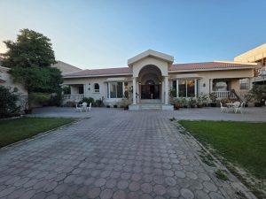 Front view of a villa for sale in Jumeirah 3 Dubai with private garden and driveway