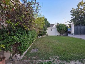 Private garden of a villa for sale in Jumeirah 3 Dubai with green lawn and outdoor space