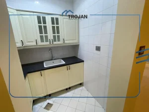 Service kitchen in a 5 bedroom villa for rent in Al Barsha with built-in cabinets