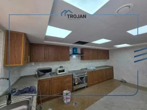 Fully fitted modern kitchen with wooden cabinets in stand-alone 5 bedroom villa for rent in Al Quoz 2 Dubai