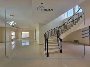 Spacious living area with elegant staircase in stand-alone 5 bedroom villa for rent in Al Quoz 2 Dubai